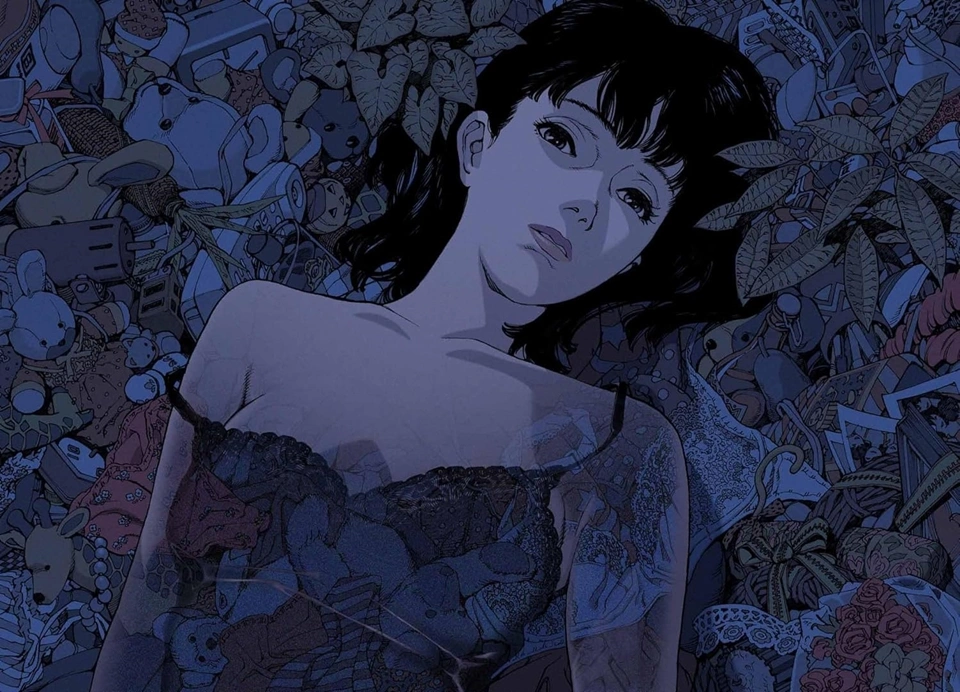 Mima Kirigoe lying among scattered personal objects and debris in a dark blue-toned scene from Perfect Blue.